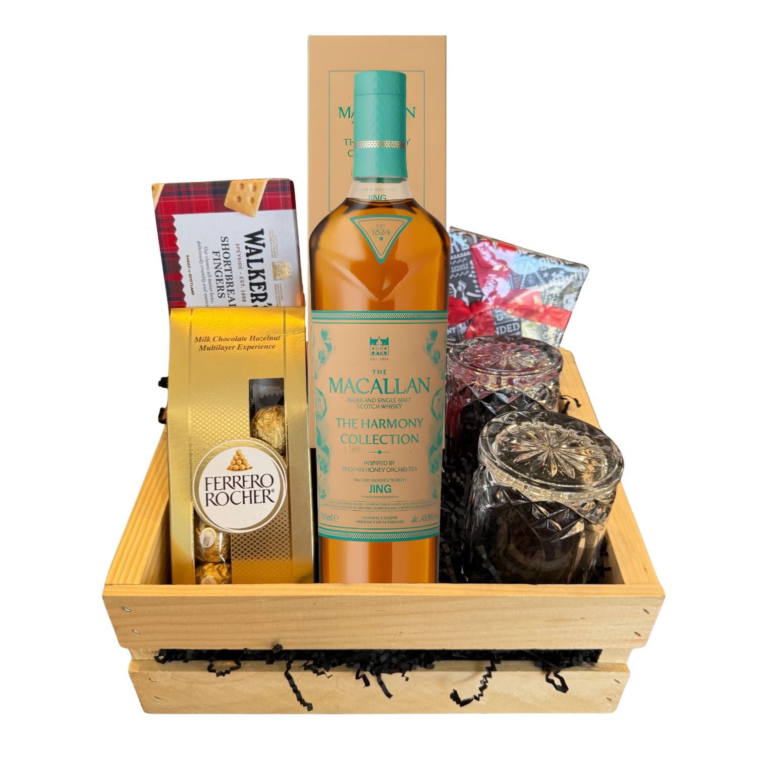 The Macallan Harmony Collection Phoenix Honey Orchid Tea Gift Crate with scotch whisky bottle, crystal glasses, whiskey stones, Ferrero Rocher, and Walkers shortbread on white background – Total Bourbon