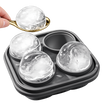 Whiskey ice mold tray with large ice spheres and spoon on white background