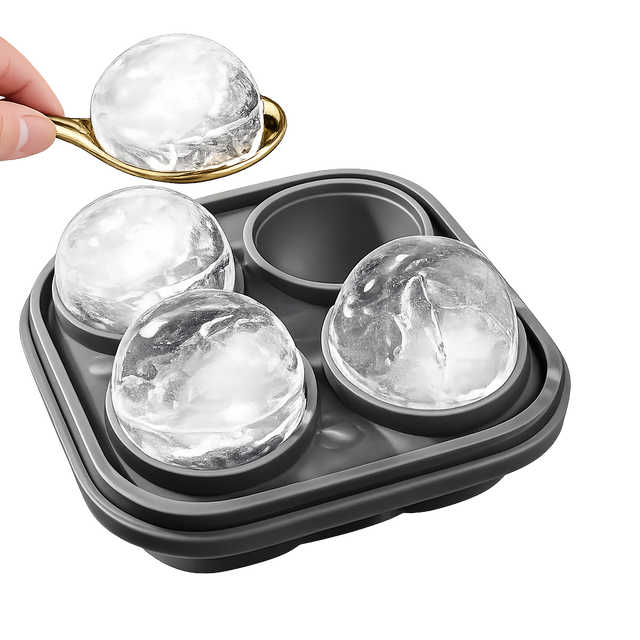 Whiskey ice mold tray with large ice spheres and spoon on white background