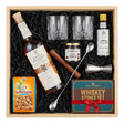 Basil Hayden's Old-Fashioned cocktail gift crate with Basil Hayden's Kentucky Straight Bourbon Whiskey with copper band and cork cap, crystal-cut old fashioned glasses, Angostura bitters, premium muddler, bar spoon, jigger, Peninsula cocktail cherries, La Perruche sugar cubes, and Royal Reserve whiskey stones set all nestled in black zigzag crinkle paper inside wooden crate on white background