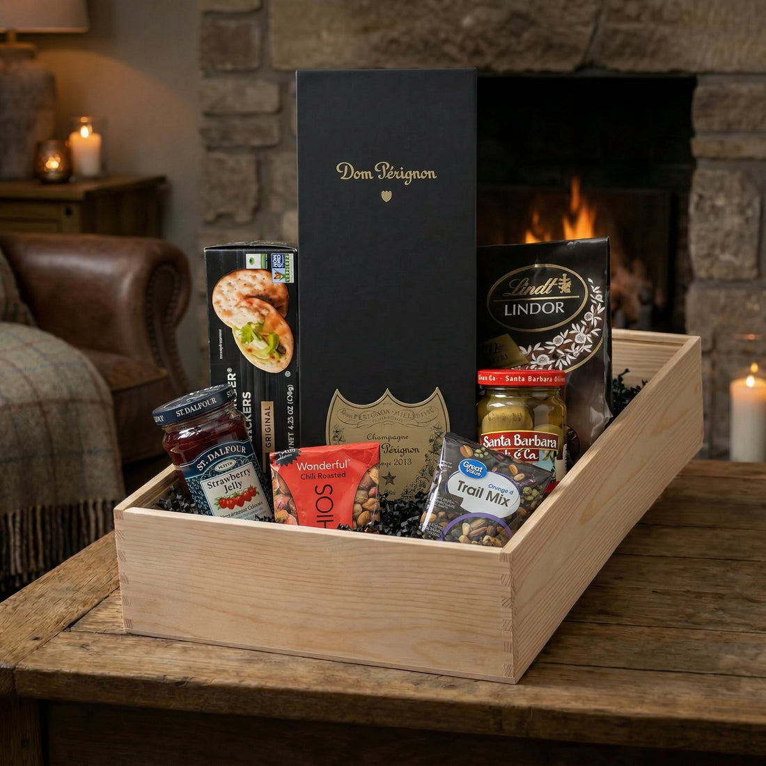 Dom Pérignon Vintage Brut Champagne 750ml luxury gift crate with gourmet pairings including crackers, olives, chocolates, and pistachios in a gift crate