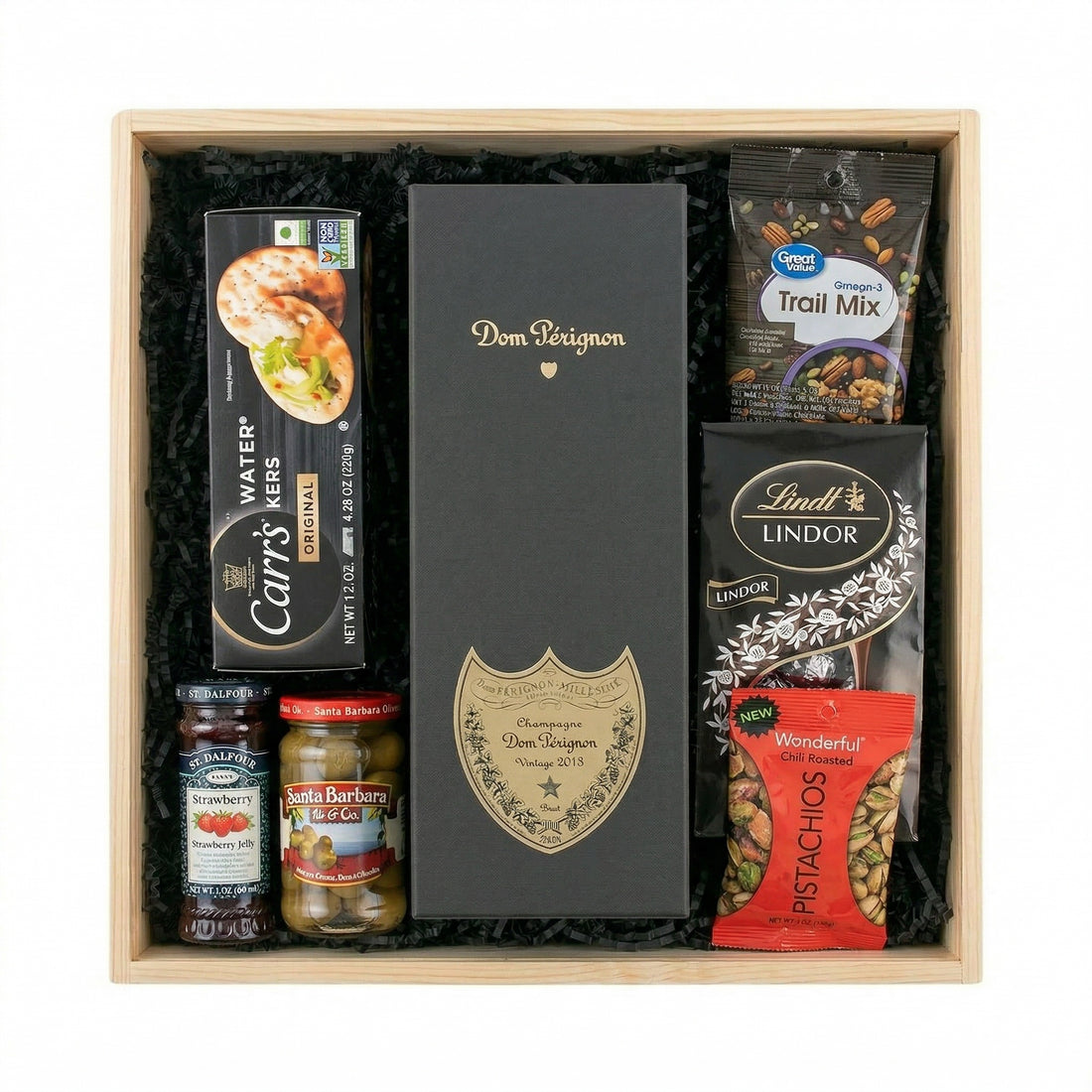 Dom Pérignon Vintage Brut Champagne 750ml luxury gift crate with gourmet pairings including crackers, olives, chocolates, and pistachios in a gift crate