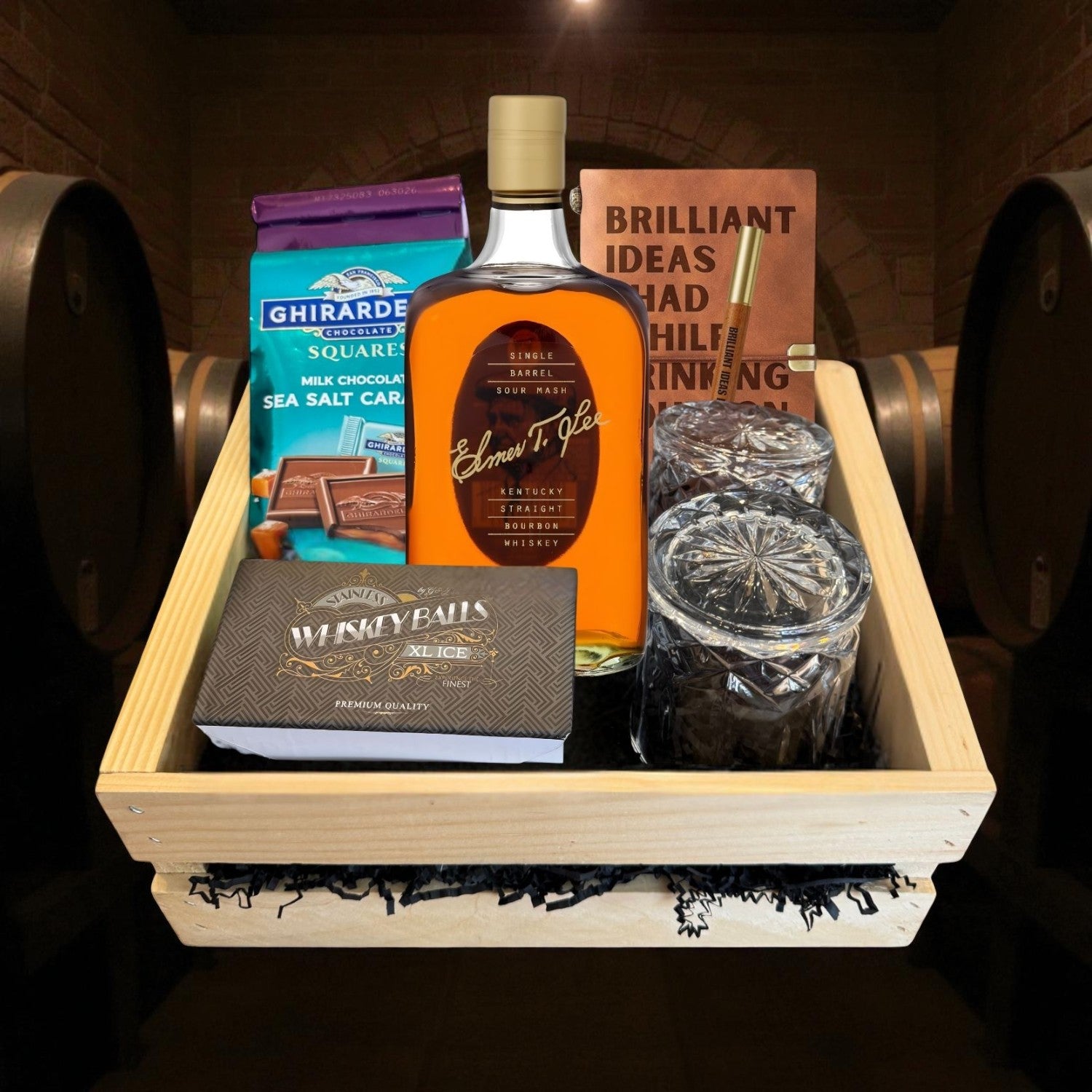 Engravable Elmer T. Lee Single Barrel Bourbon Gift Crate with premium accessories in a wooden crate displayed in a barrel room setting – luxury bourbon presentation from Top Bourbon