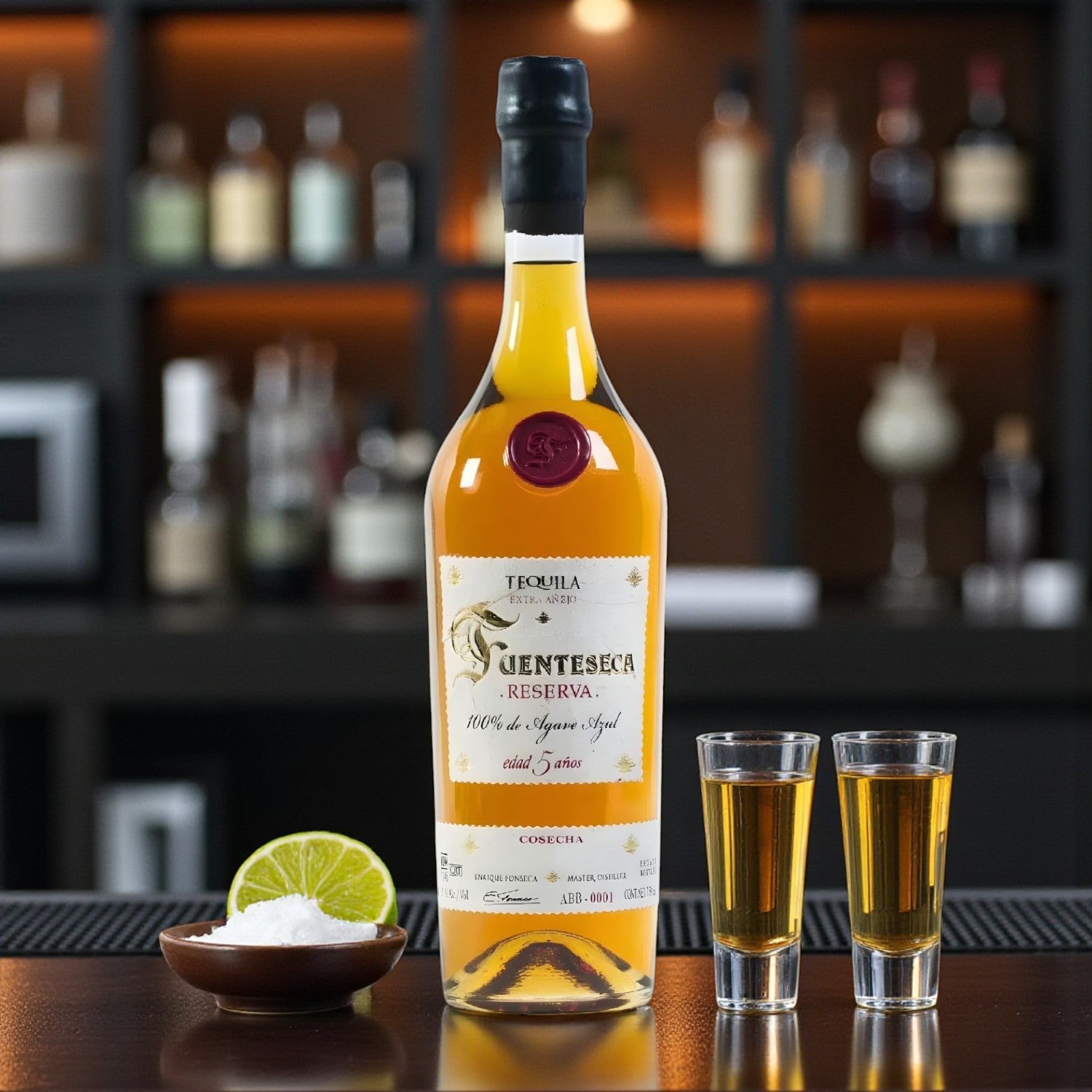 Engravable Fuenteseca Reserva 5 Year Extra Añejo Tequila Limited Edition bottle on bar with two shot glasses and lime – Top Bourbon lifestyle image