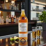Engravable Fuenteseca Reserva 7 Year Extra Añejo Tequila Limited Release bottle with shot glasses and lime on polished bar – Top Bourbon lifestyle image