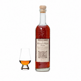 High West A Midwinter Night's Dram rye whiskey bottle beside a Glencairn tasting glass on white