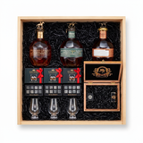 Blanton's Executive gift crate with three Blanton's bourbon editions, three Glencairn-style glasses, three whiskey stones sets, and a hand-finished wooden accessory box with a cutter and lighter, nested in a natural wood crate.
