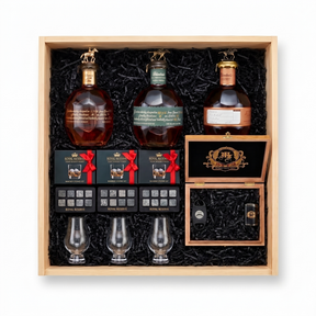 Blanton's Executive gift crate with three Blanton's bourbon editions, three Glencairn-style glasses, three whiskey stones sets, and a hand-finished wooden accessory box with a cutter and lighter, nested in a natural wood crate.