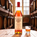Engravable Pappy Van Winkle Family Reserve 13 Year Straight Rye Whiskey bottle on wooden barrel table beside glass of rye – Top Bourbon lifestyle image
