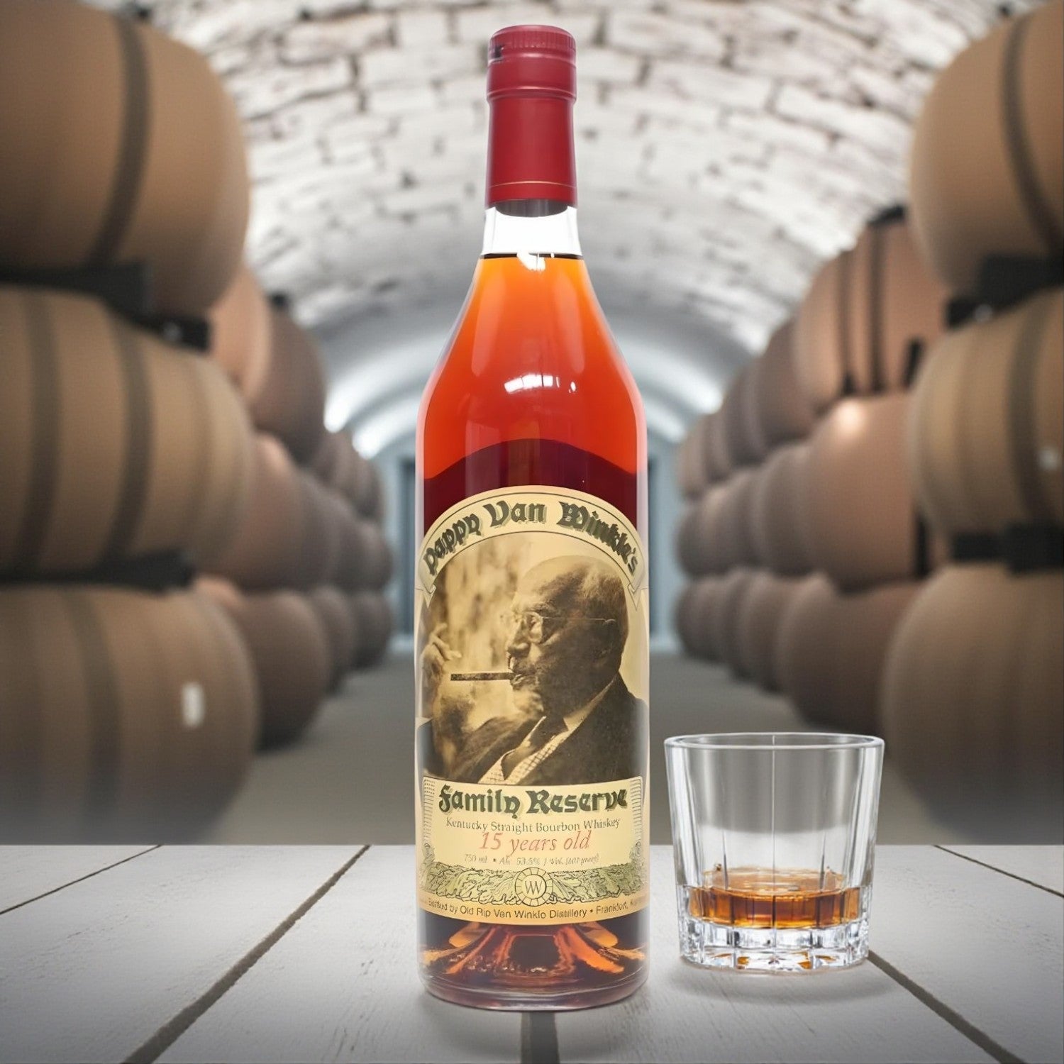 Engravable Pappy Van Winkle Family Reserve 15 Year Bourbon Santa Edition 2017 Release bottle on table beside glass of bourbon in barrel cellar – Top Bourbon lifestyle image